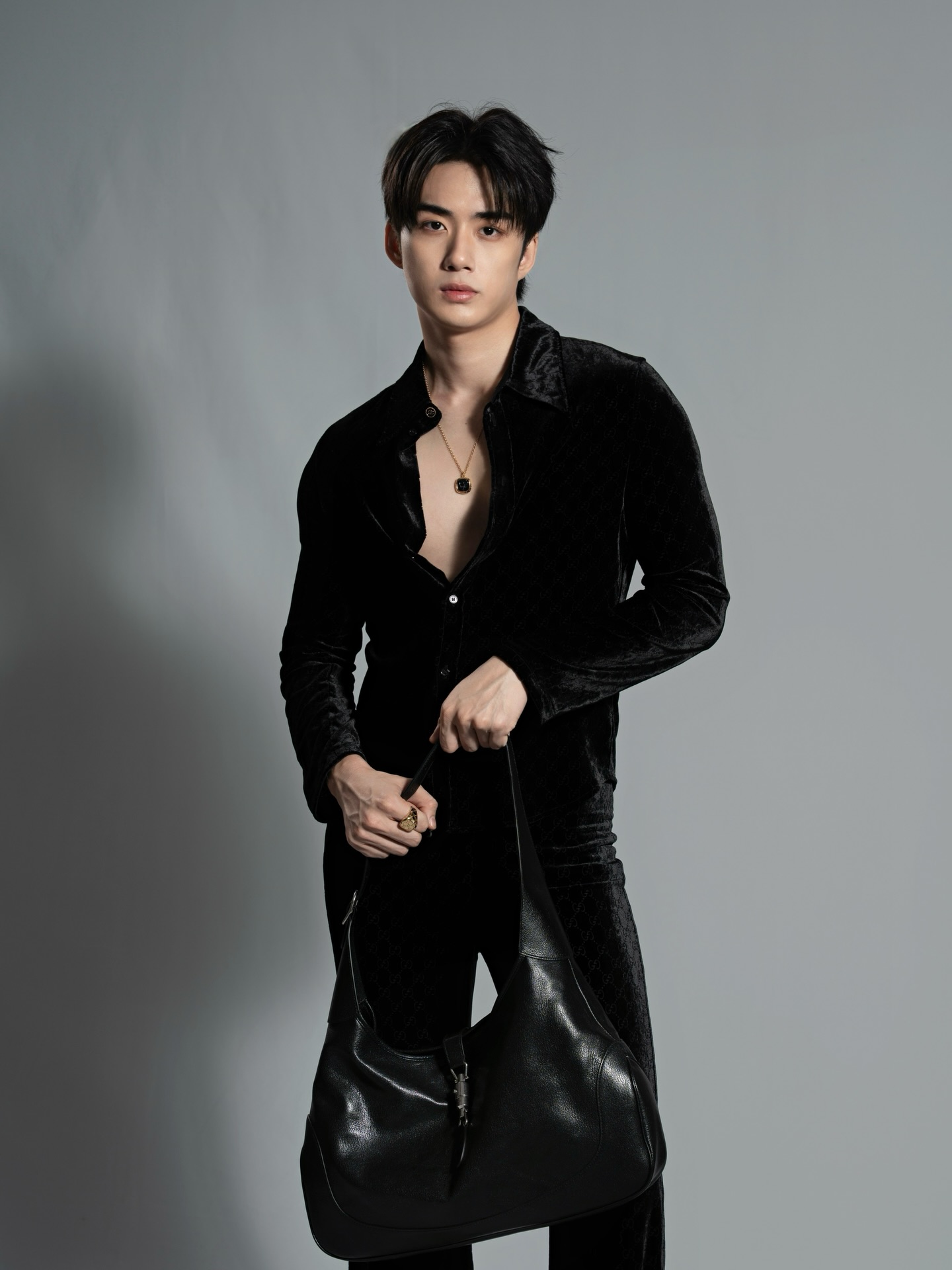 YANG YAN in a black velvet shirt against a grey studio backdrop